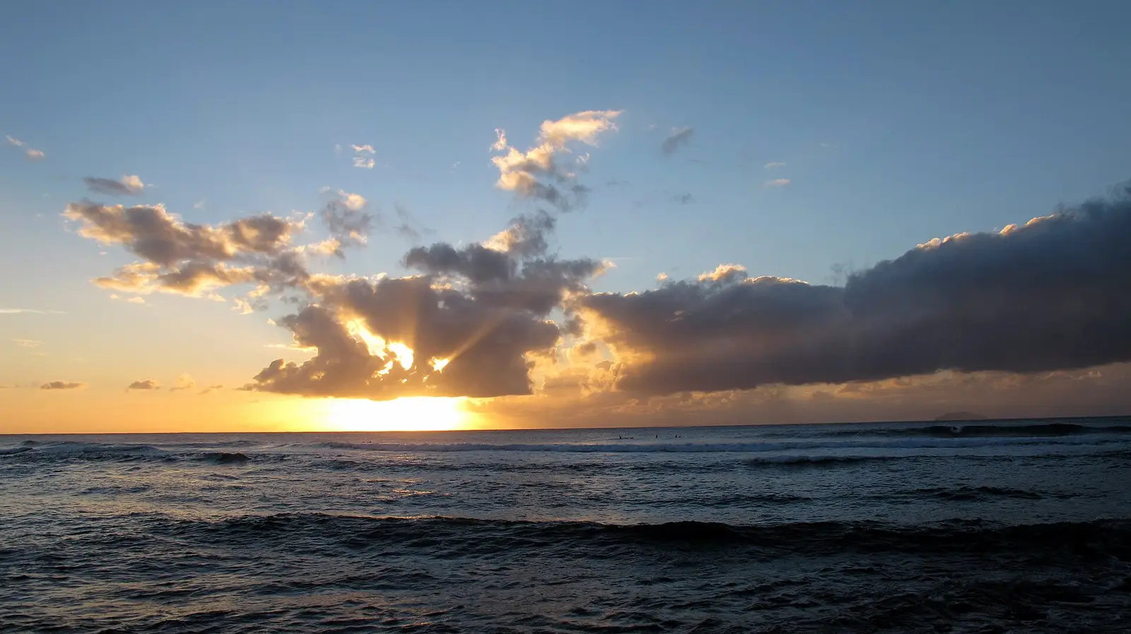 Surfers at sunset at Maria's Beach in Rincón, Puerto Rico